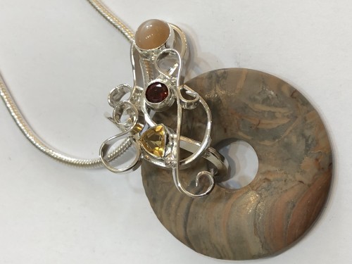 Jasper donut pendant with solid silver curls set with pink moonstone, citrine and garnet